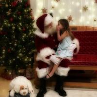 Annberlynn Newberry whispers to Santa