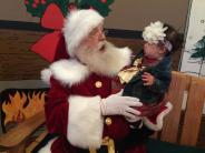 Santa and little girl look at each other